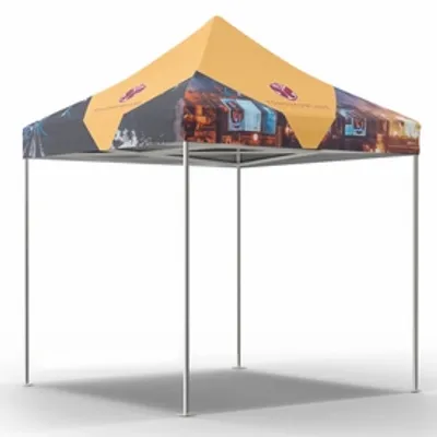 A custom-printed trade show tent with images on the valance and peak, standing in a plain white space.